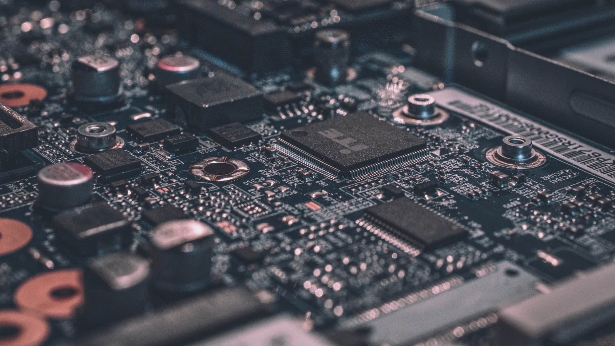 Close-up of a dense printed circuit board with microchips and components