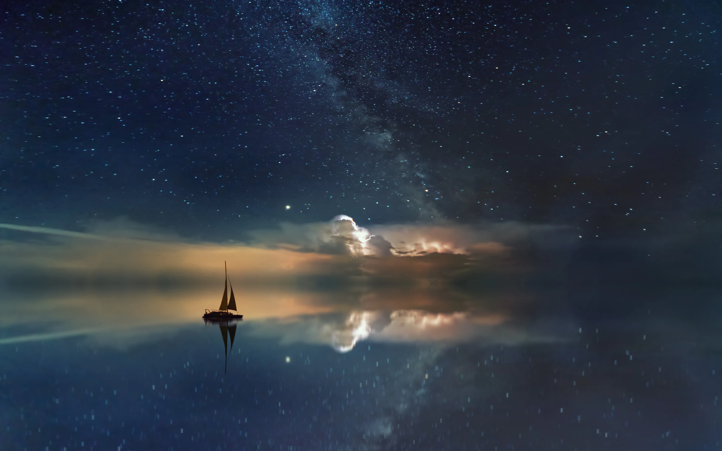 A lone sailboat on a mirror-still sea beneath a star-filled night sky