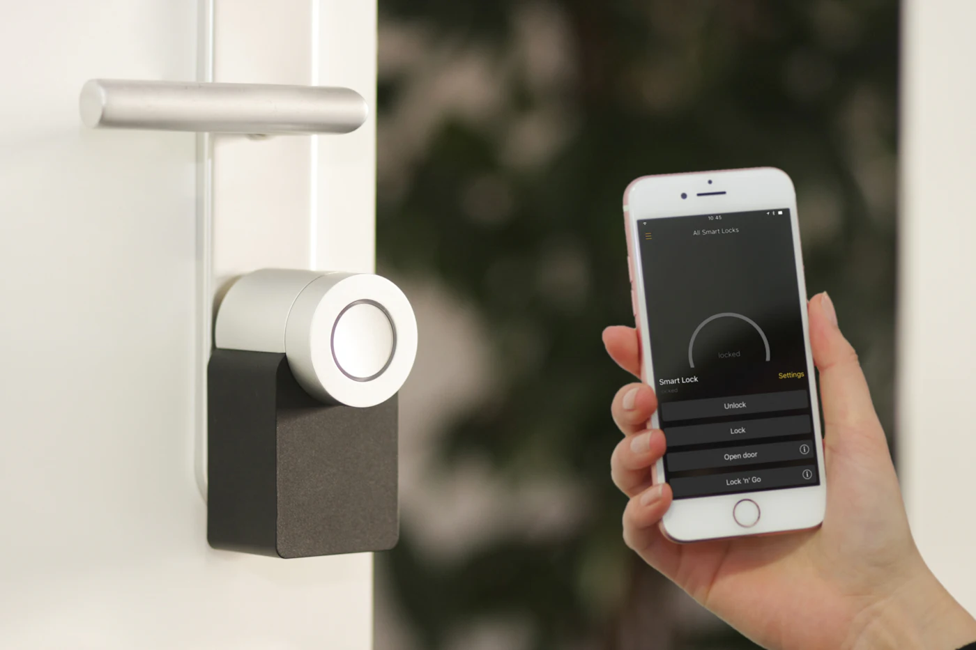 A smart lock fitted to a door being controlled from a smartphone app