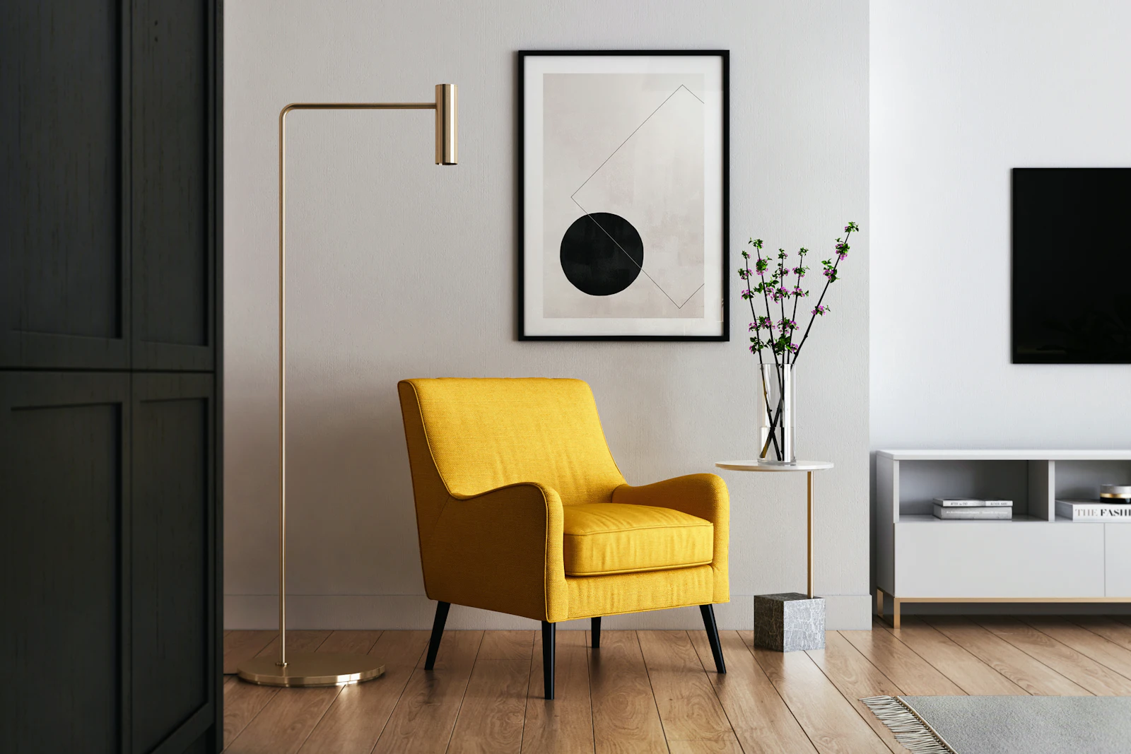 A minimalist living room with a yellow armchair, brass floor lamp and framed print