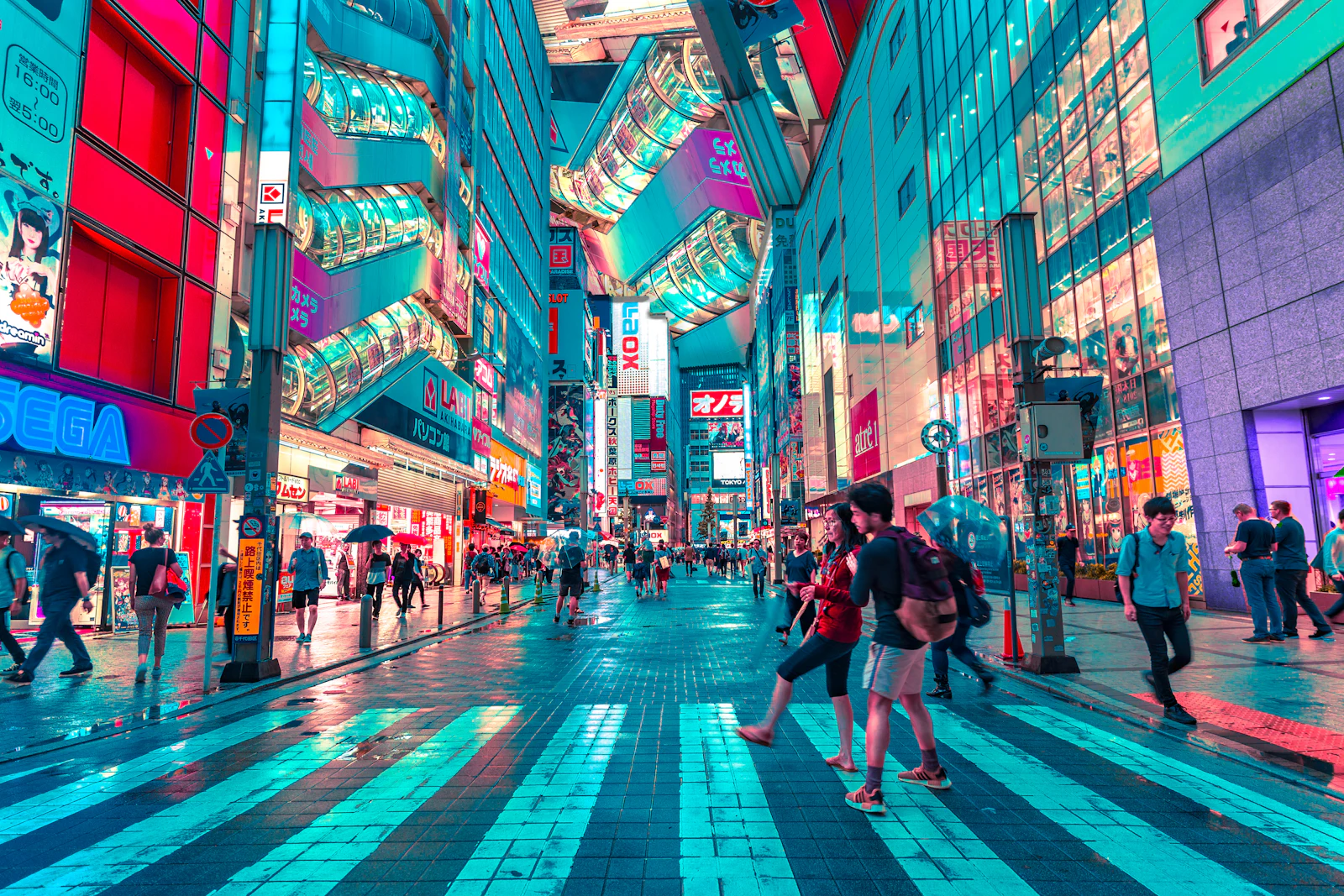 Pedestrians crossing a neon-lit Tokyo street at night