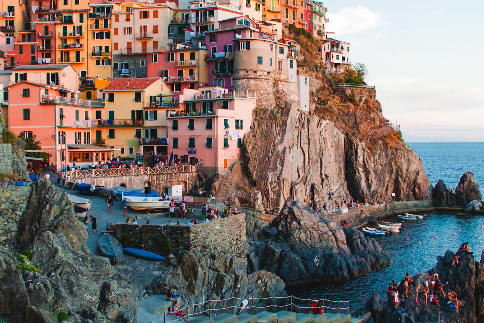Colourful cliffside houses of an Italian coastal village above a calm sea